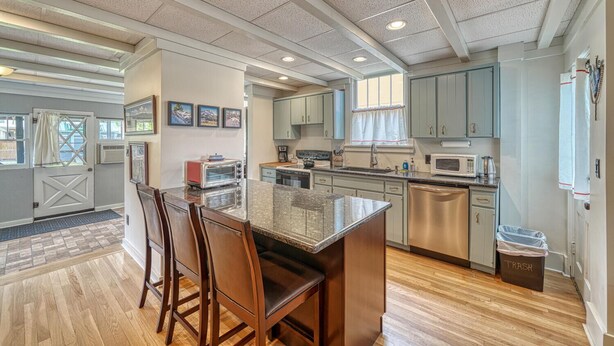 A modern kitchen with granite countertops, stainless steel appliances, and wooden chairs. - Nita's Place- Live like a local! Close to town! (Salida)