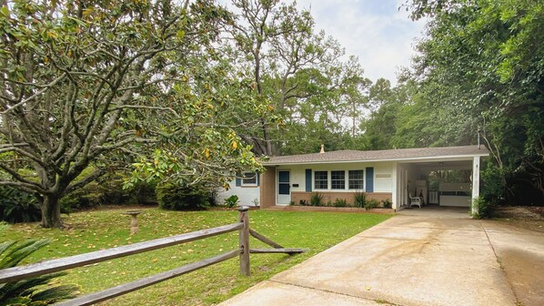 A single-story house with a front porch, a garage, and a well-maintained lawn.