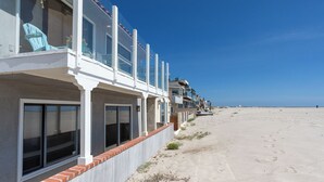 A beachfront hotel with balconies, large windows, and a sandy beach in the background. - 1213O Local's Choice at Silverstrand (Oxnard)