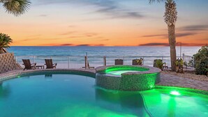 A pool with a sunset view, lounge chairs, and a palm tree. - Not the Norm - Oceanfront Home with Private Pool & Beach Access (Miramar Beach)