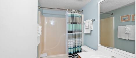 A bathroom with a bathtub, toilet, and sink.