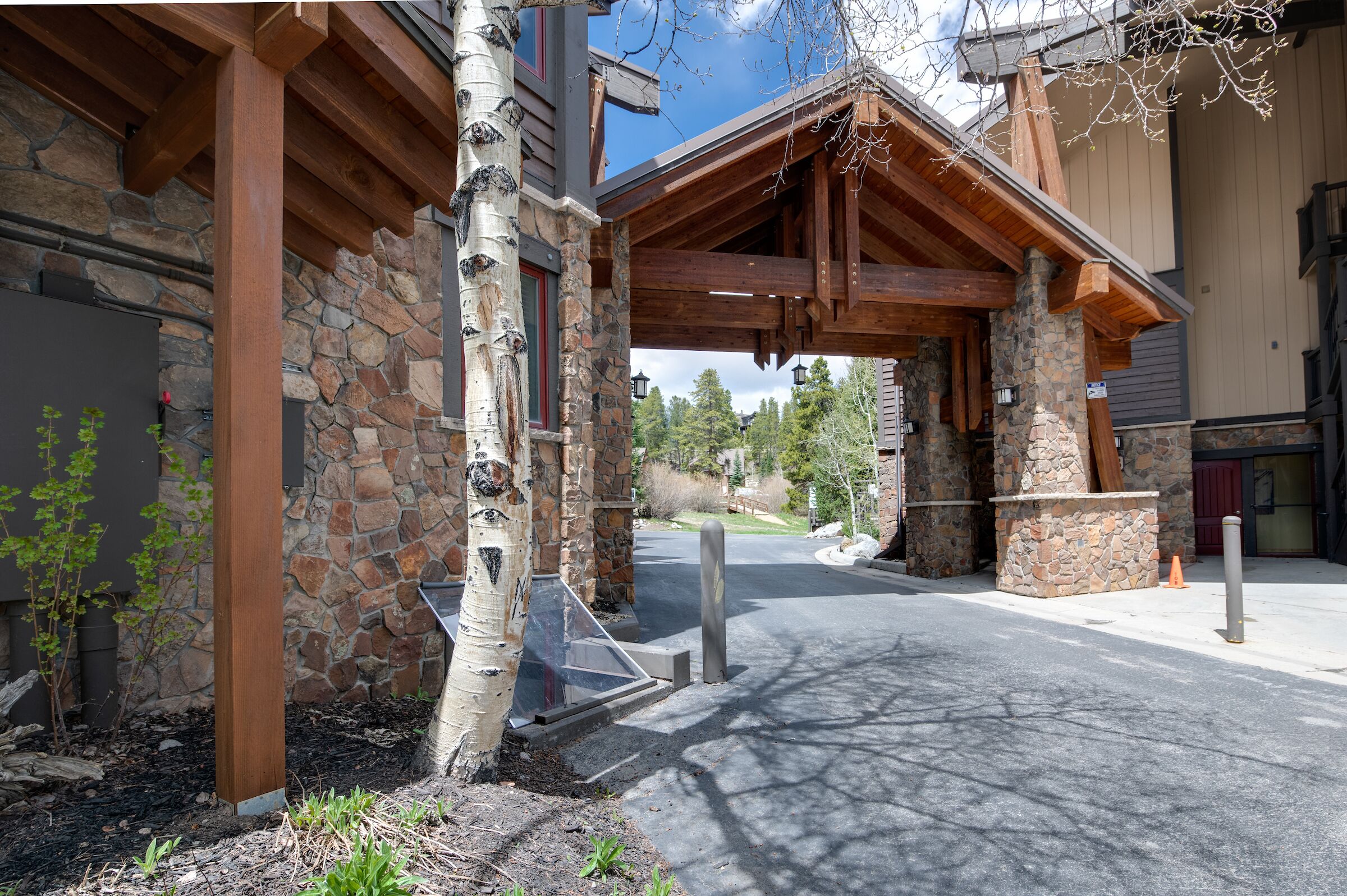 A stone building with a wooden entrance and a view of the surrounding landscape.