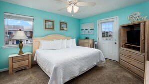 A bedroom with a bed, a nightstand, a dresser, a television, and a ceiling fan. - 19 GulfBreeze Court👙Destin, FL🐟Pet Friendly🐶 (Destin)