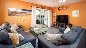 A living room with a sofa, a coffee table, and a television. - 19 GulfBreeze Court👙Destin, FL🐟Pet Friendly🐶 (Destin)