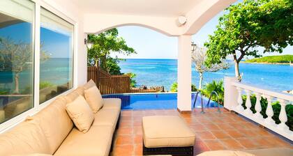 Relax into luxury at our West End beachfront villa—with private pool