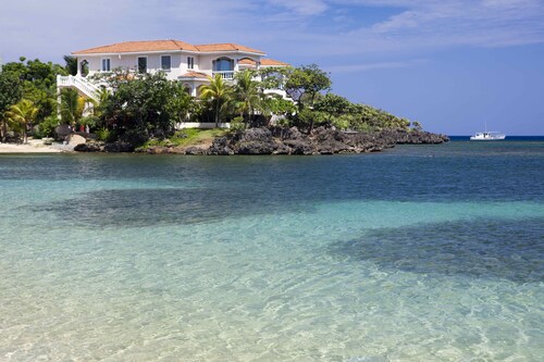 Relax into luxury at our West End beachfront villa—with private pool