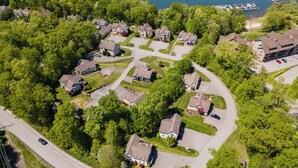 An aerial view of a residential area with houses, a marina, and a road. - Hot Tub, Fire Pit & Stunning Lake Views (Oakland)