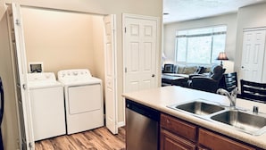 A compact kitchen with a dishwasher, a built-in oven, and a sink. - Fortune's Edge Retreat by Mesquite Vacation Rentals: Ground Level with 2 Car Garage and $510 in free daily activities (Mesquite)