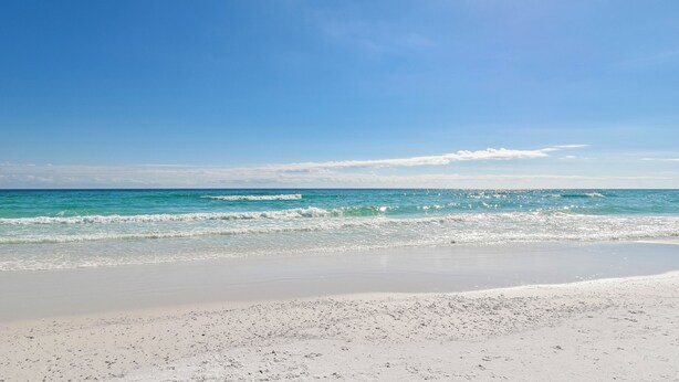A beach with clear blue water, a sandy shore, and a clear sky. - Serene Condo w/ Stunning Gulf Views on Scenic 98 in Miramar Beach! 🌊☀🏖 (Miramar Beach)