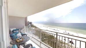 A balcony with a view of a beach and ocean. - Master Gulf View Upgraded in 2023 Free round of Golf & Activities Every Day! (Panama City Beach)