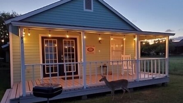 A small house with a porch, a door, and a window. - Laguna Flats Lodge. 3 Bedroom, 2 Bath. Close to Public Pier or Boat Launch. (Port Mansfield)