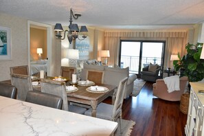 Enjoy a meal in the dining area with a marble table and comfortable seating.