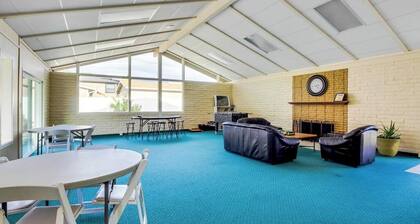 Dog-friendly waterfront home with pool, tennis courts, & large lawn