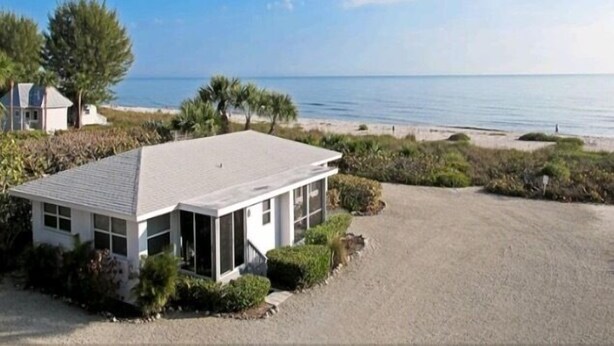 A modern house with a large garage and a view of the beach.