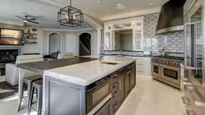 A modern kitchen with a large island, stainless steel appliances, and a sleek design. - 33 Dune Lane- Oceanfront & Beautiful! (Hilton Head Island)