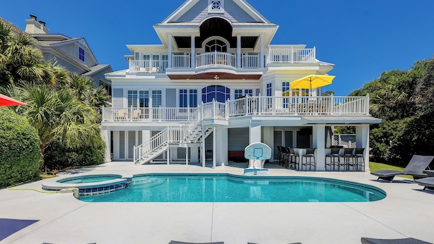 A large, two-story house with a swimming pool, outdoor seating, and a basketball hoop. - 33 Dune Lane- Oceanfront & Beautiful! (Hilton Head Island)