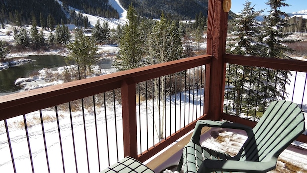 A balcony with a view of a snow-covered landscape, including a river and mountains. - On River Trail! End Unit Near Hot Tubs. Walk to Festivals, Dining, Shops (Keystone)