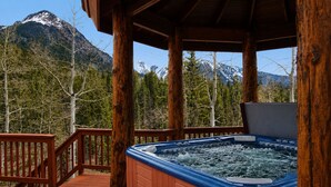 A hot tub on a wooden deck with a mountain view. - Rustic & Spacious Log Cabin w/Private Hot Tub, Amazing Views, 4 Miles to Ski (Durango)