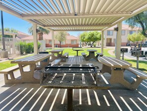 Enjoy al fresco dining and social gatherings in this charming outdoor space with a barbecue grill and picnic tables.