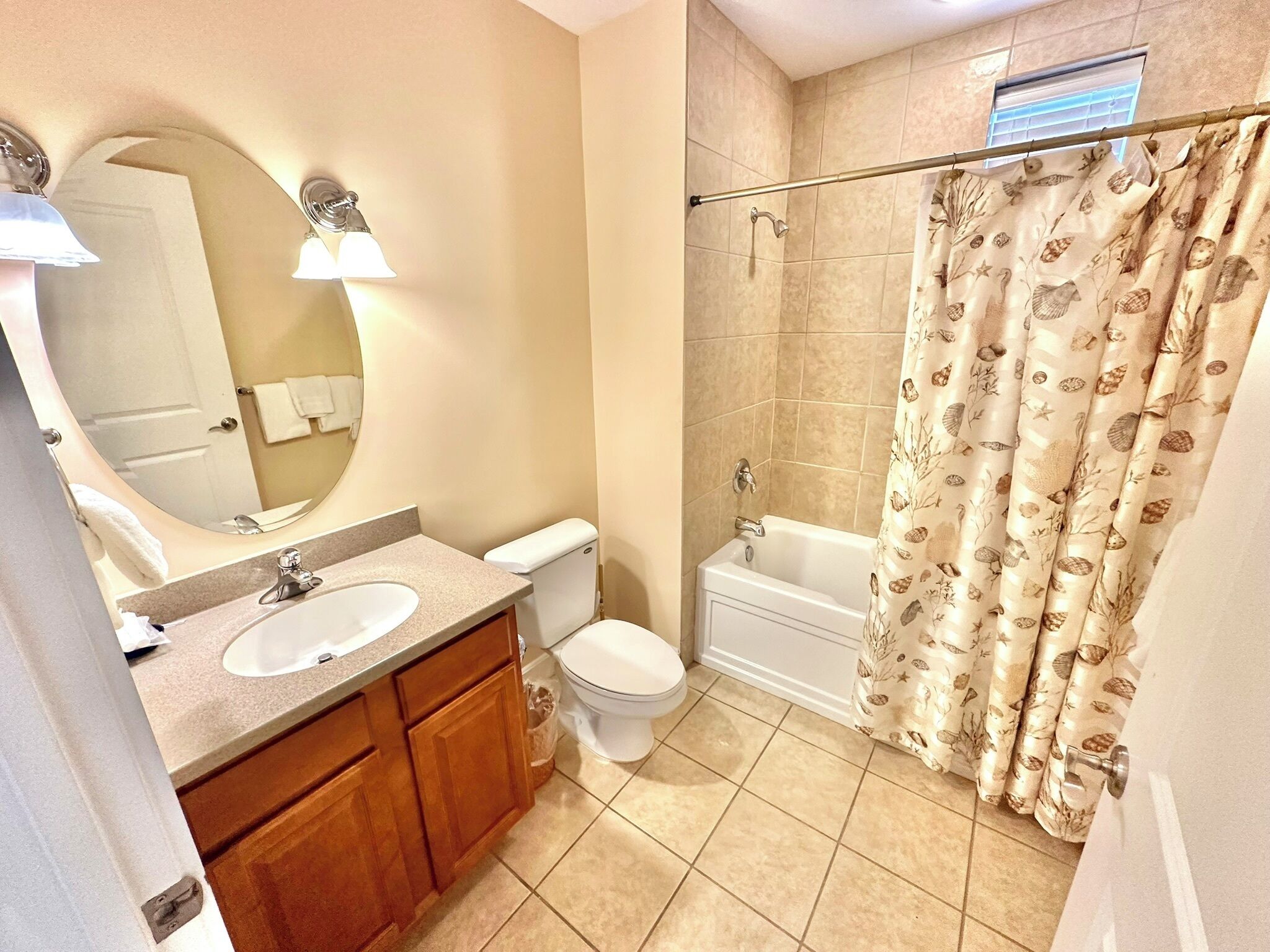 A bathroom with a sink, toilet, and bathtub.