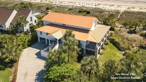 A two-story house with a wooden roof, surrounded by palm trees and a beach view. - Van Horne Villa | Beautiful Home, Ocean Views! (Tybee Island)
