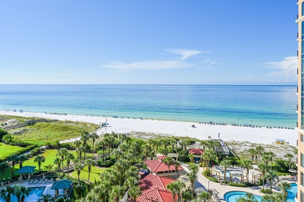 A resort with a beach view, a pool area, and a golf course.