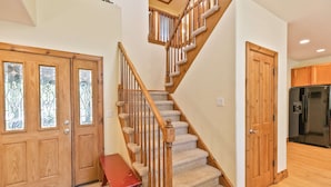 A staircase with wooden railings and carpeted steps leading to a second floor. - Highland Greens Fairway Townhome: Hot Tub, Views (Breckenridge)