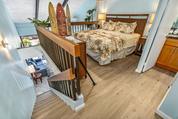 A bedroom with a bed, wooden headboard, bedside tables, and a view of the outside. - Maui Vista #1-418 Ocean View/Pickle Ball Courts, Close to the Beach, Wifi (Kihei)