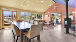 A spacious living area with a dining table, sofas, and a fireplace. - • Dog Friendly • Walk to Everything • Great Outdoor Space! (Salida)