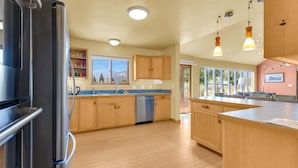 A modern kitchen with wooden cabinets, a stainless steel refrigerator, a dishwasher, and pendant lighting. - • Dog Friendly • Walk to Everything • Great Outdoor Space! (Salida)