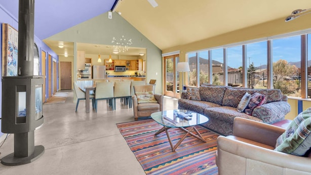 A spacious living area with a sofa, coffee table, and a view of the kitchen and dining area. - • Dog Friendly • Walk to Everything • Great Outdoor Space! (Salida)