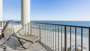 A balcony with a view of the ocean, a chair, and a railing. - The Oasis At Orange Beach 808 by Liquid Life (Orange Beach)