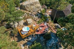 An aerial view of a resort with a hot tub, outdoor seating, and a small building. - Dramatic Geodesic Dome with amazing views, AC, spa and walk to town cold tub (Idyllwild)