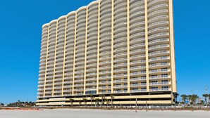 A high-rise hotel with multiple balconies, a flat roof, and a beachside location. - Affordable!Luxurious!BeachFront!TopFlrCondo!ReservedParking!Beach Service Included (Panama City Beach)