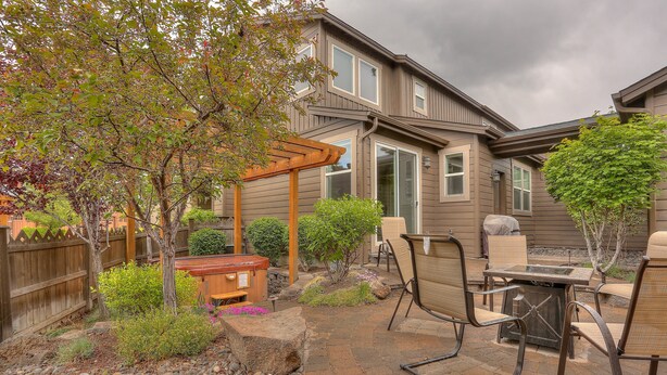 Un espace extérieur aménagé avec une pergola, des sièges et un jacuzzi.
