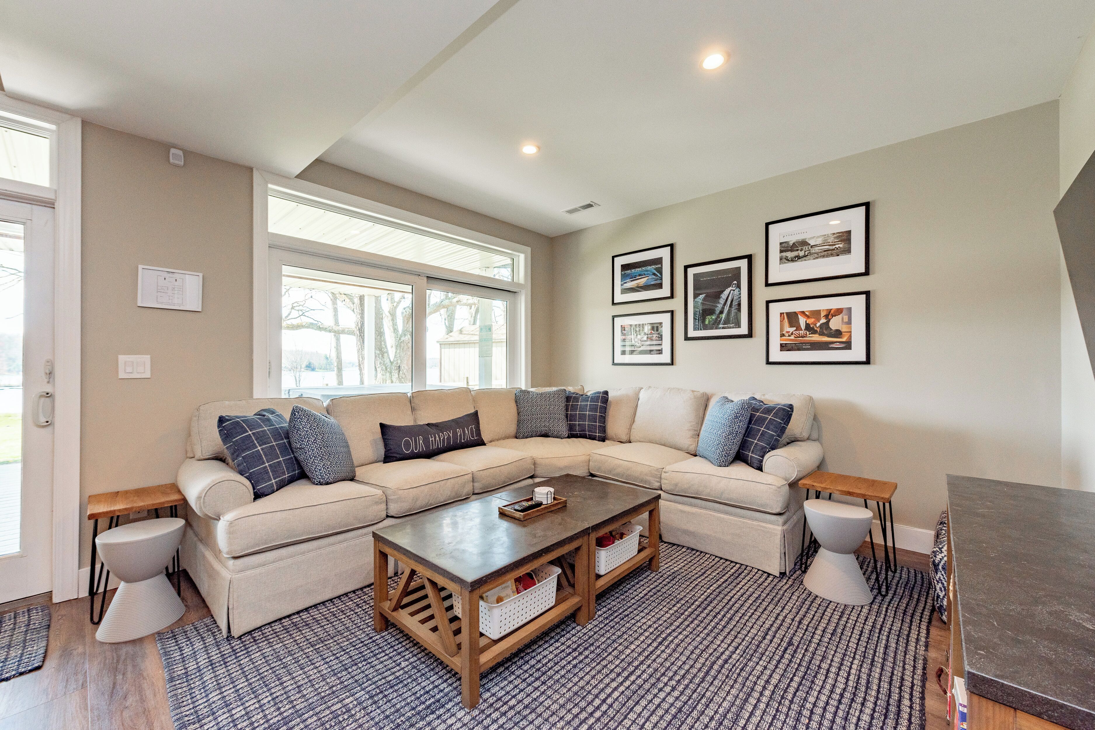 A living room with a sectional sofa, a coffee table, and a fireplace.