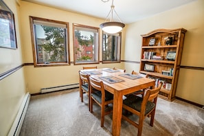 Enjoy meals in this cozy dining area with a wooden table and six comfortable chairs.