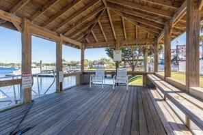 Relax on the deck with a view of the marina and boats.