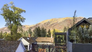 A modern house with a large window and a view of a mountain. - Charming condo in the core, dynamite location (Aspen)