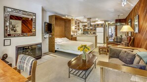 A compact, modern room with a bed, a sofa, a dining table, and a kitchenette. - Charming condo in the core, dynamite location (Aspen)