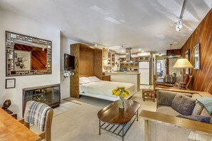 A compact, modern room with a bed, a sofa, a dining table, and a kitchenette. - Charming condo in the core, dynamite location (Aspen)