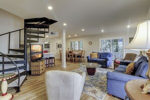 Relax in a spacious living area with a spiral staircase, comfortable seating, and a dining table.