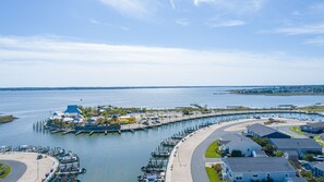 A marina with docks, boats, and a waterfront property with houses.