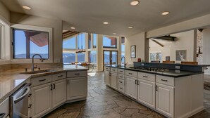 A spacious kitchen with a large island, granite countertops, and a view of the mountains. - Big Sky - Lakeview - TLUXP (Truckee)