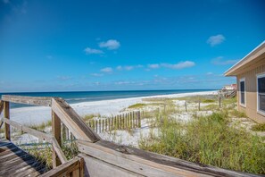 A wooden boardwalk leading to a beach with a clear blue sky. - Idle Hours - Pet Friendly! Gulf Front in Dune Allen Beach (Santa Rosa Beach)