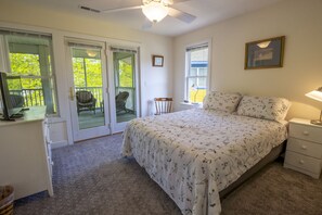 A bedroom with a bed, a desk, a chair, a nightstand, and a ceiling fan. - 5 Beds in Beachwalk Resort - Beach, Pool, Stocked Lake & Lake Michigan Access (Michigan City)