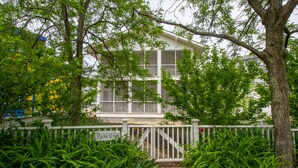 A two-story house with a white exterior, a covered porch, and a gated entrance. - 5 Beds in Beachwalk Resort - Beach, Pool, Stocked Lake & Lake Michigan Access (Michigan City)