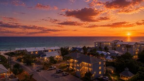A coastal hotel with multiple buildings, a view of the ocean, and a sunset. - "Inlet Sands 204" | 1 min. walk to beach | Community Pool | Bike to Rosemary (Inlet Beach)