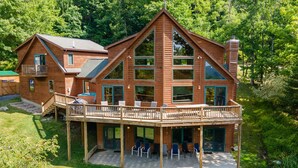 A large wooden cabin with a balcony and multiple windows. - Mountain Chalet w/ Hot Tub, Views & Game Room (McHenry)