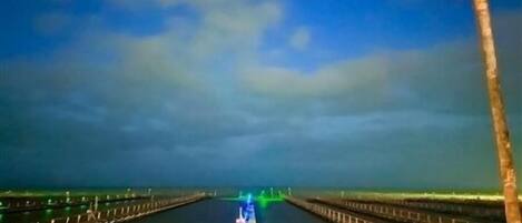 A long, narrow waterway with a wooden walkway on both sides, leading to a distant point.